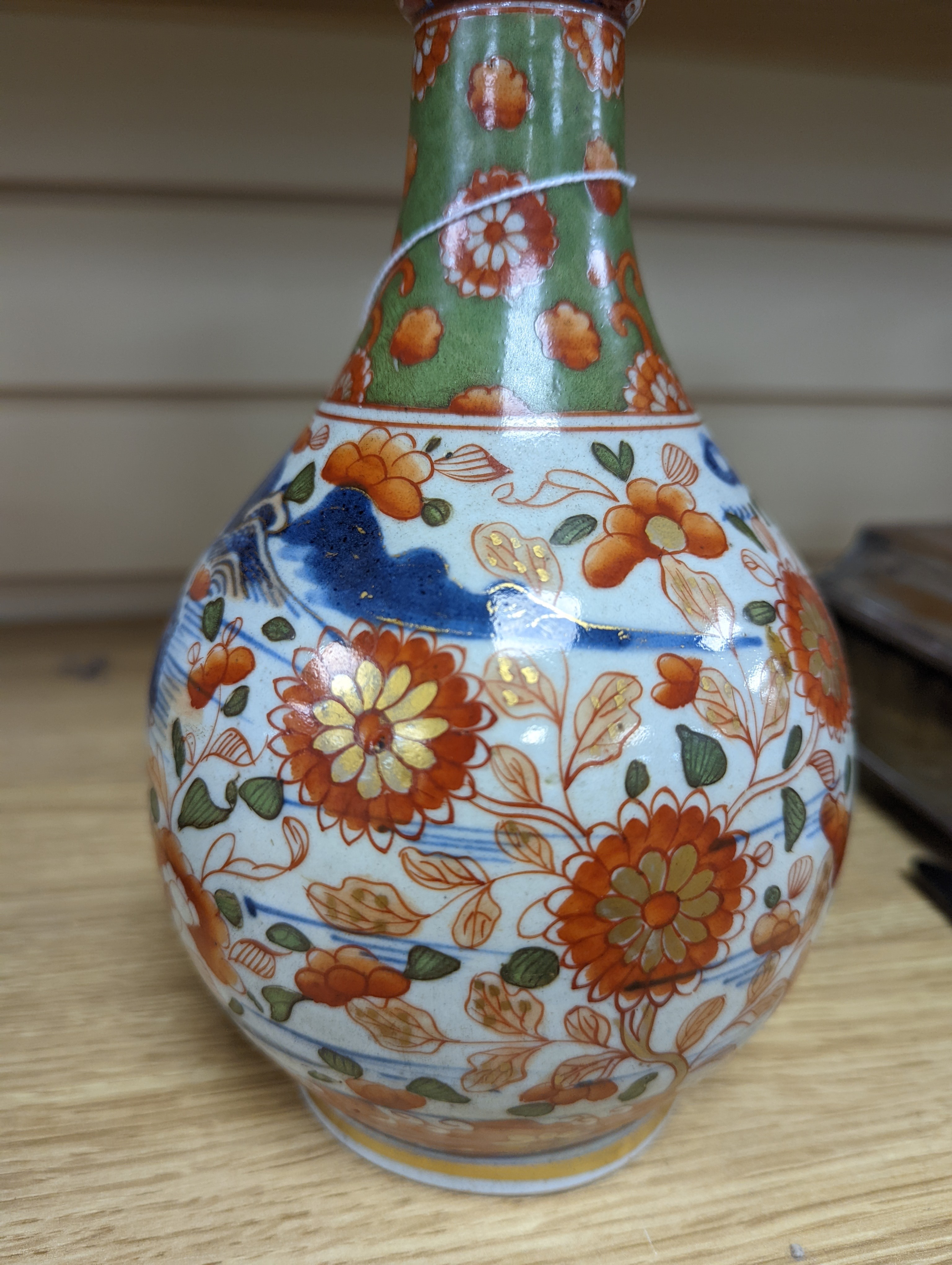 A pair of 18th century Chinese clobbered blue and white bottle vases 23cm